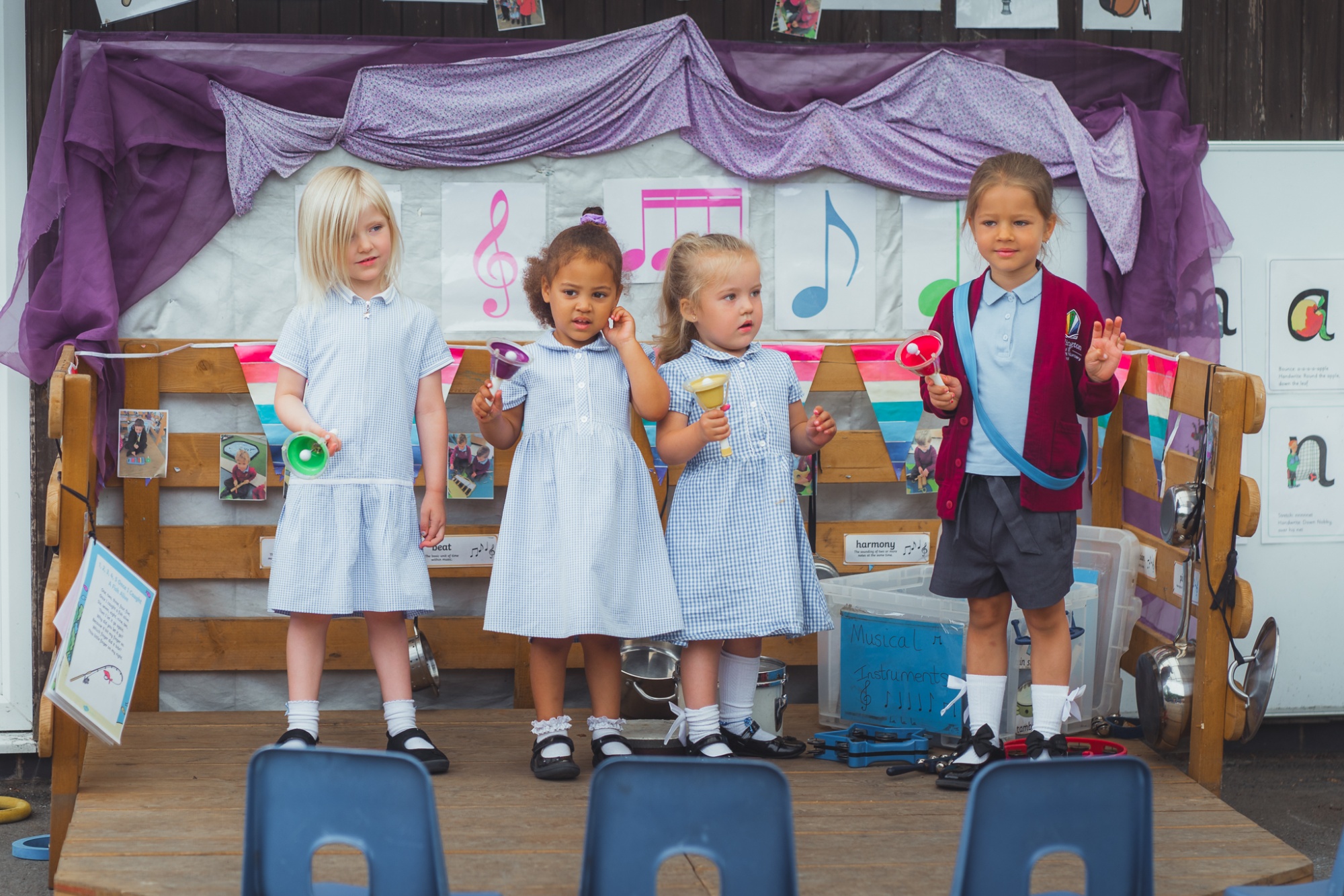 four students doing a musical performance